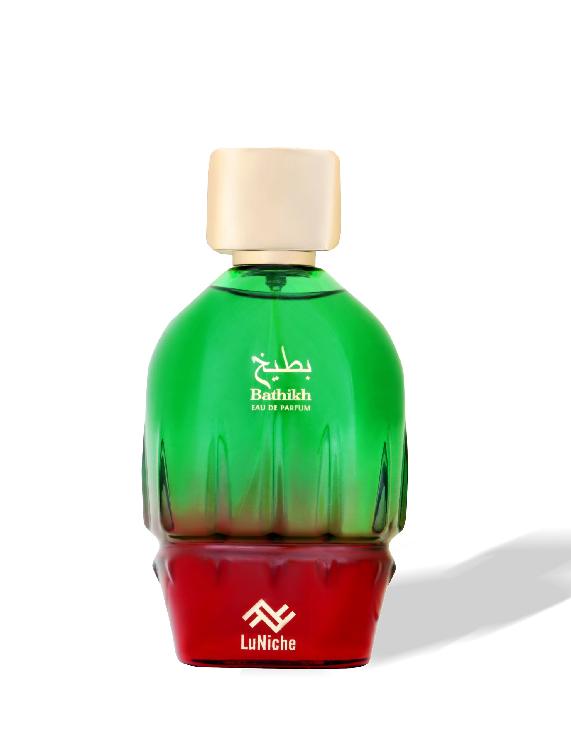Green and red perfume bottle with gold cap on a white background
